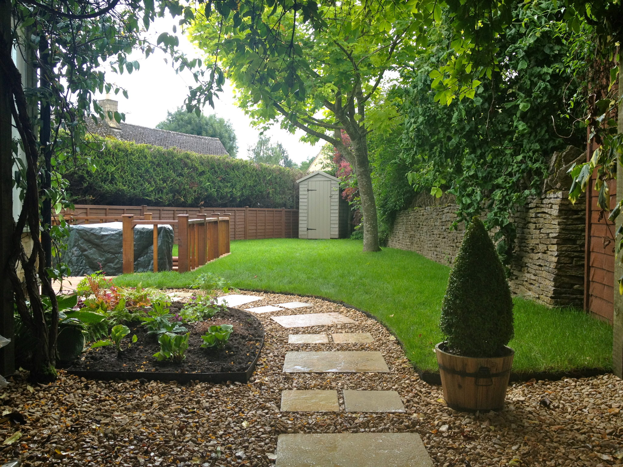 A stepping stone path set into gravel with metal edging.